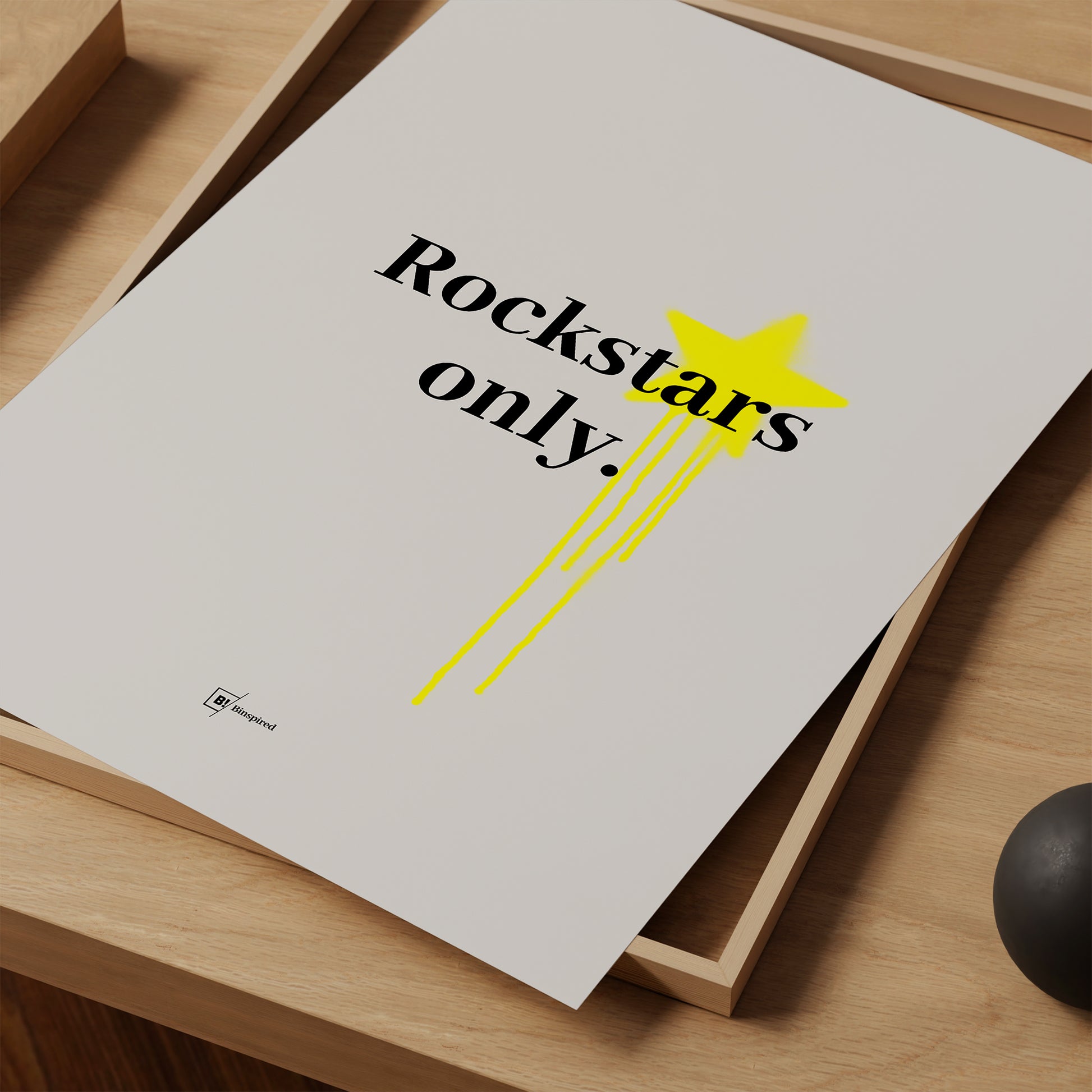 Close-up of the black text "Rockstars Only" in bold font, with yellow graffiti splatter adding a vibrant urban touch.