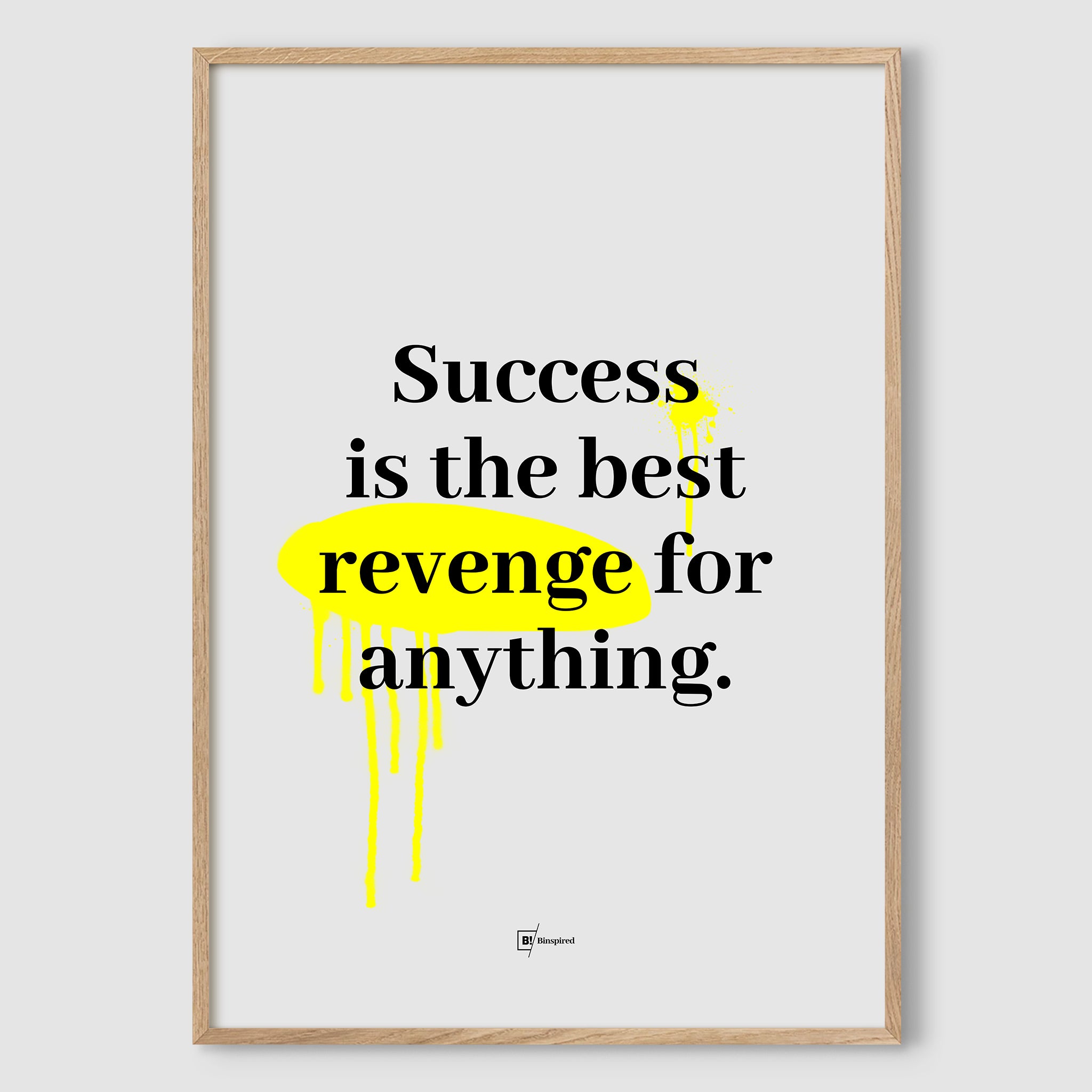 Success Is the Best Revenge for Anything art print in a natural wood frame, with modern black typography and vibrant yellow graffiti details against a minimalist gray backdrop.